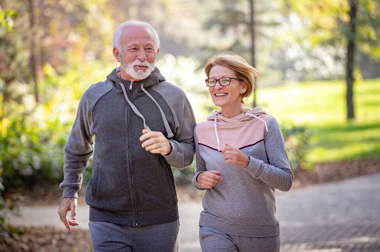 Healthy mature couple running outdoors